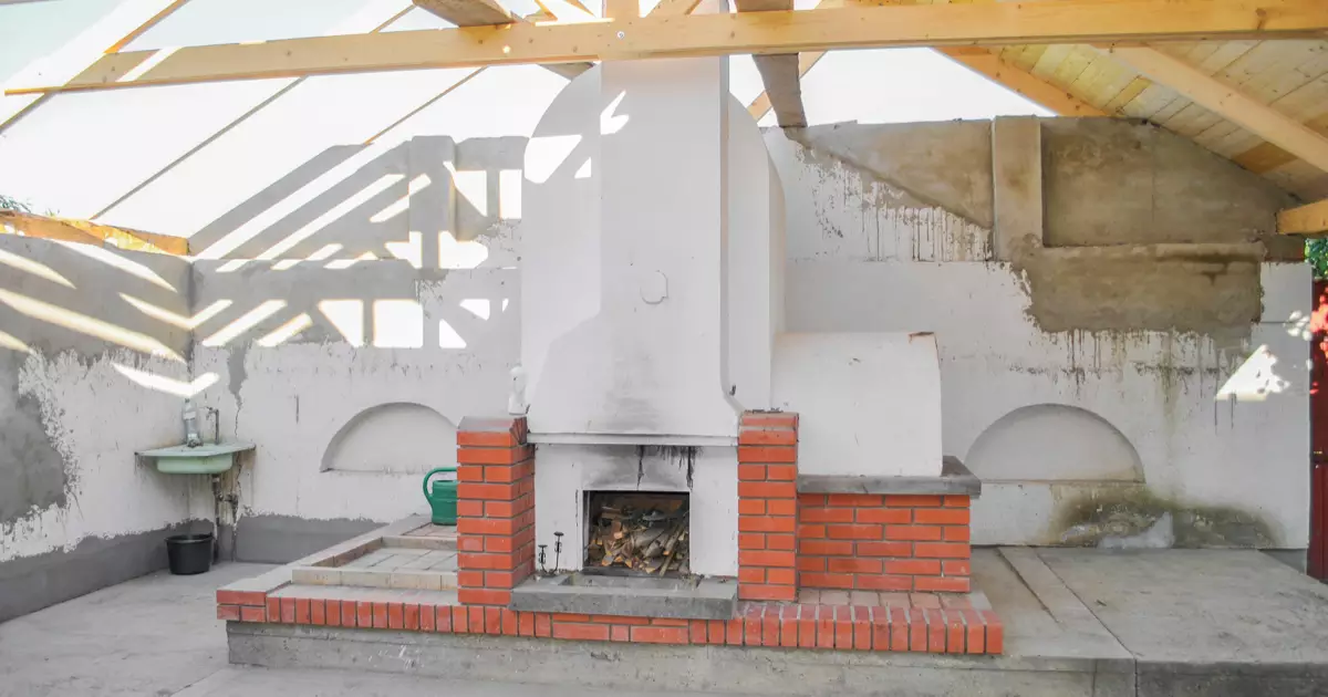 Custom outdoor stone fireplace built in a backyard