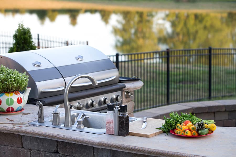 Outdoor kitchen with a granite counter and built-in grill