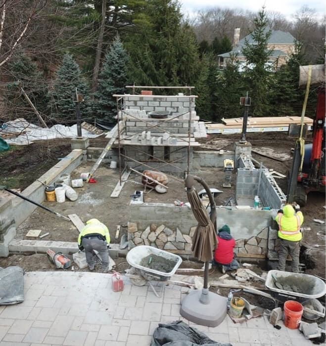 Custom outdoor pavilion kitchen with stone counters