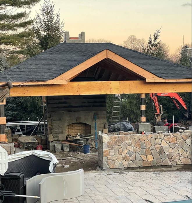 Outdoor kitchen pavilion with built-in grill and seating