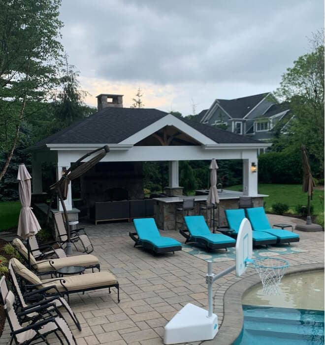 Outdoor kitchen pavilion at dusk with lighting