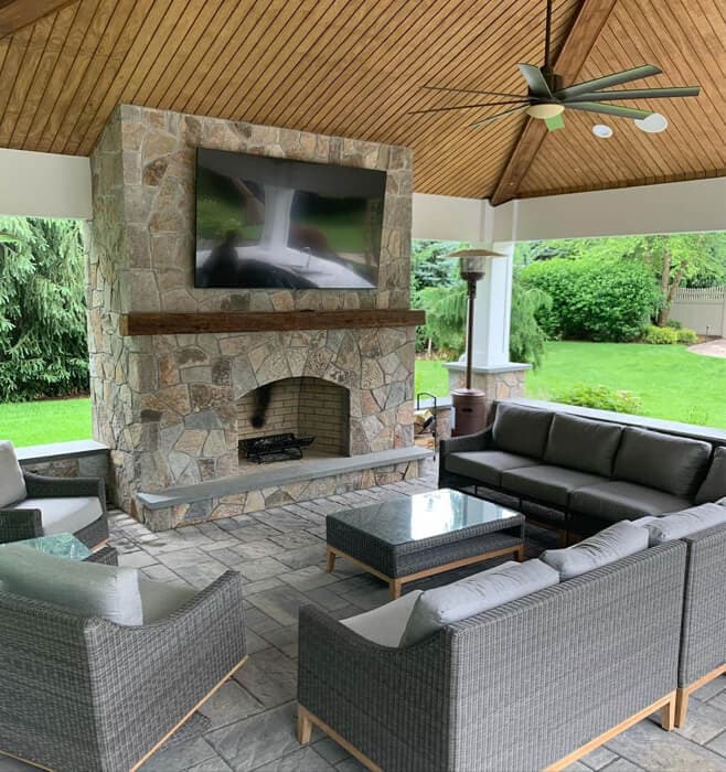 Custom outdoor living space with kitchen and entertainment system
