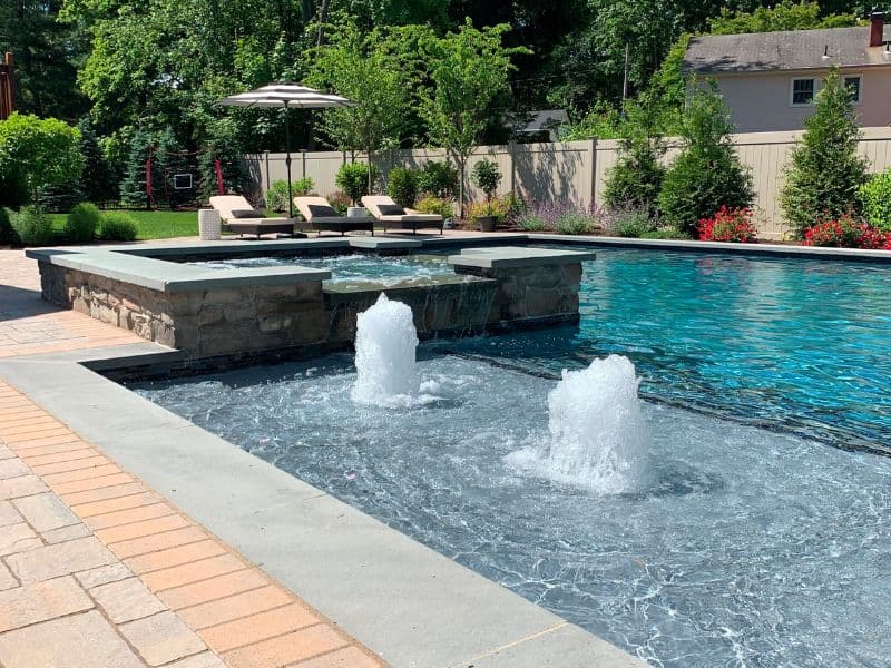 Pool with a step-down stone fountain water feature