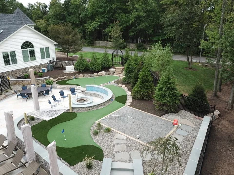 Backyard artificial turf lawn with a putting green
