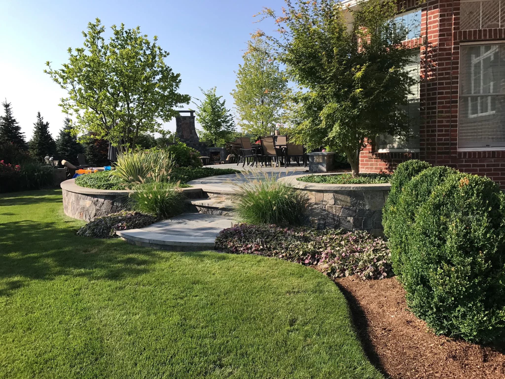 Custom masonry stone patio with cut bluestone borders