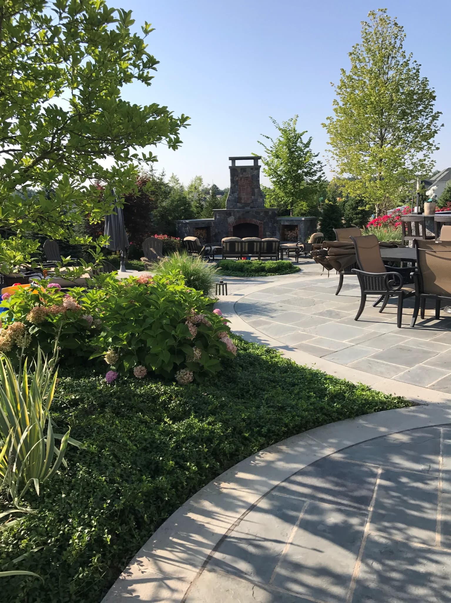 Custom stonework patio with a seat wall