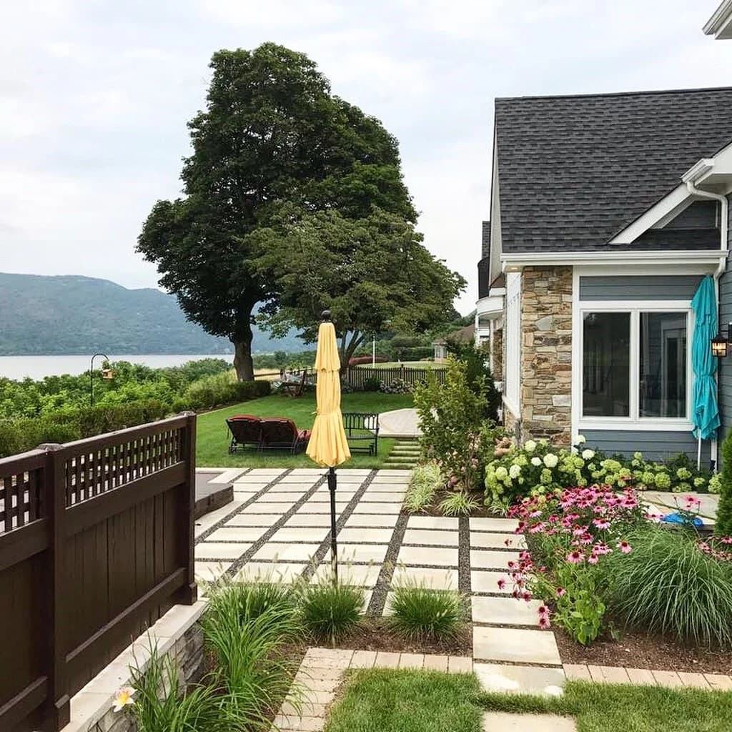 Backyard stone patio backed by a retaining wall
