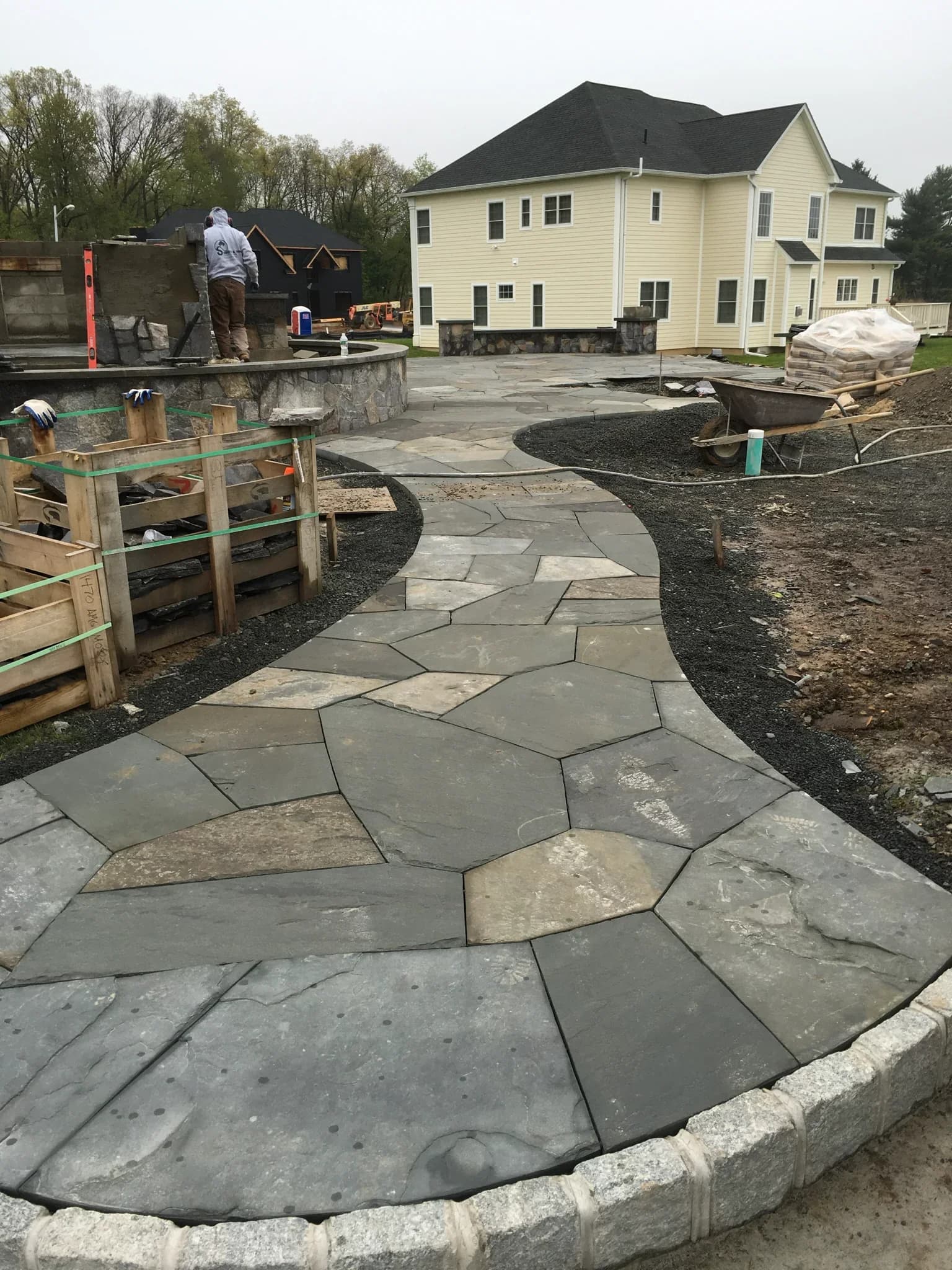 Natural stone walkway leading to a stone patio