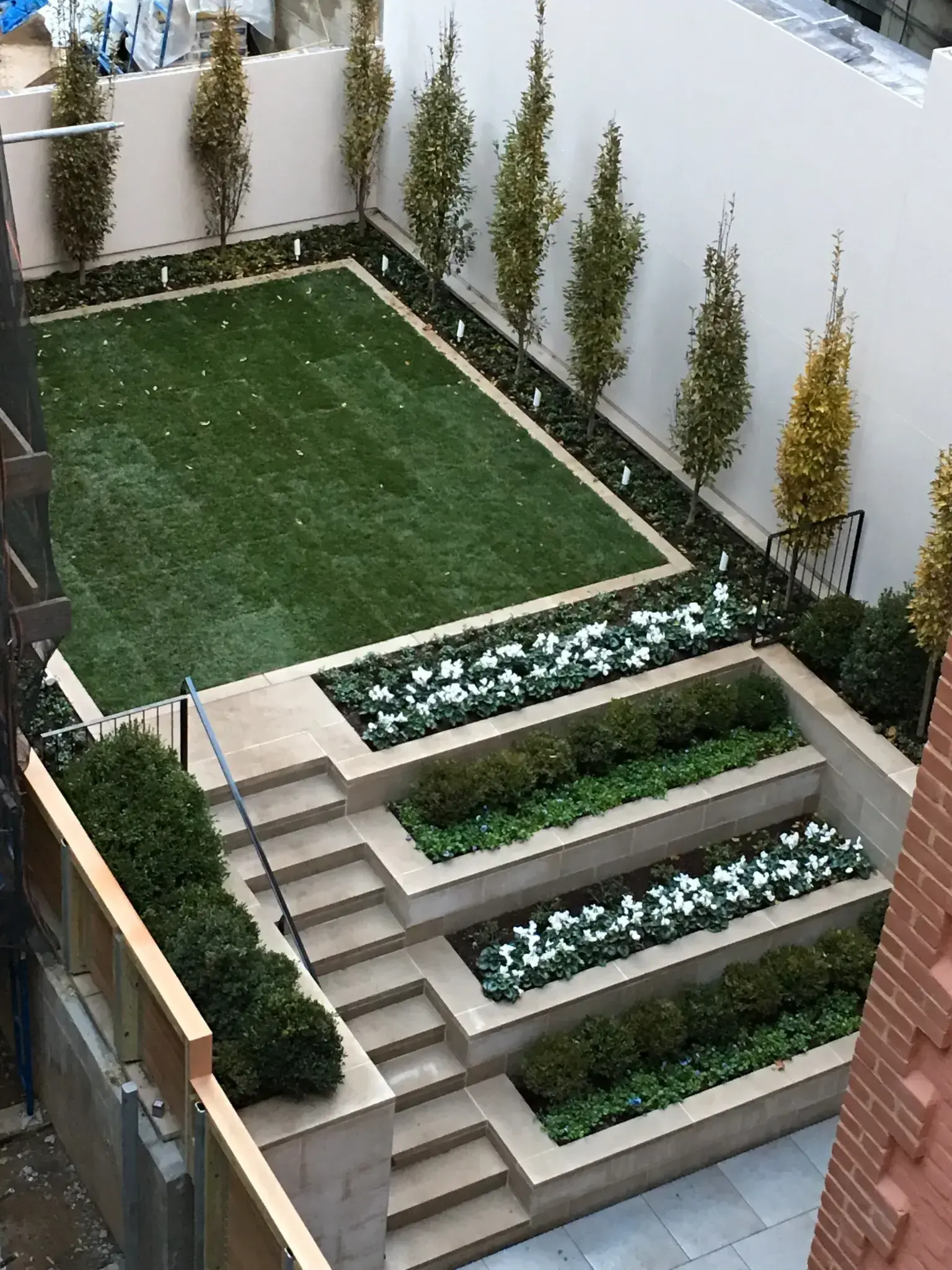 Custom stone planters built into a designed hardscape