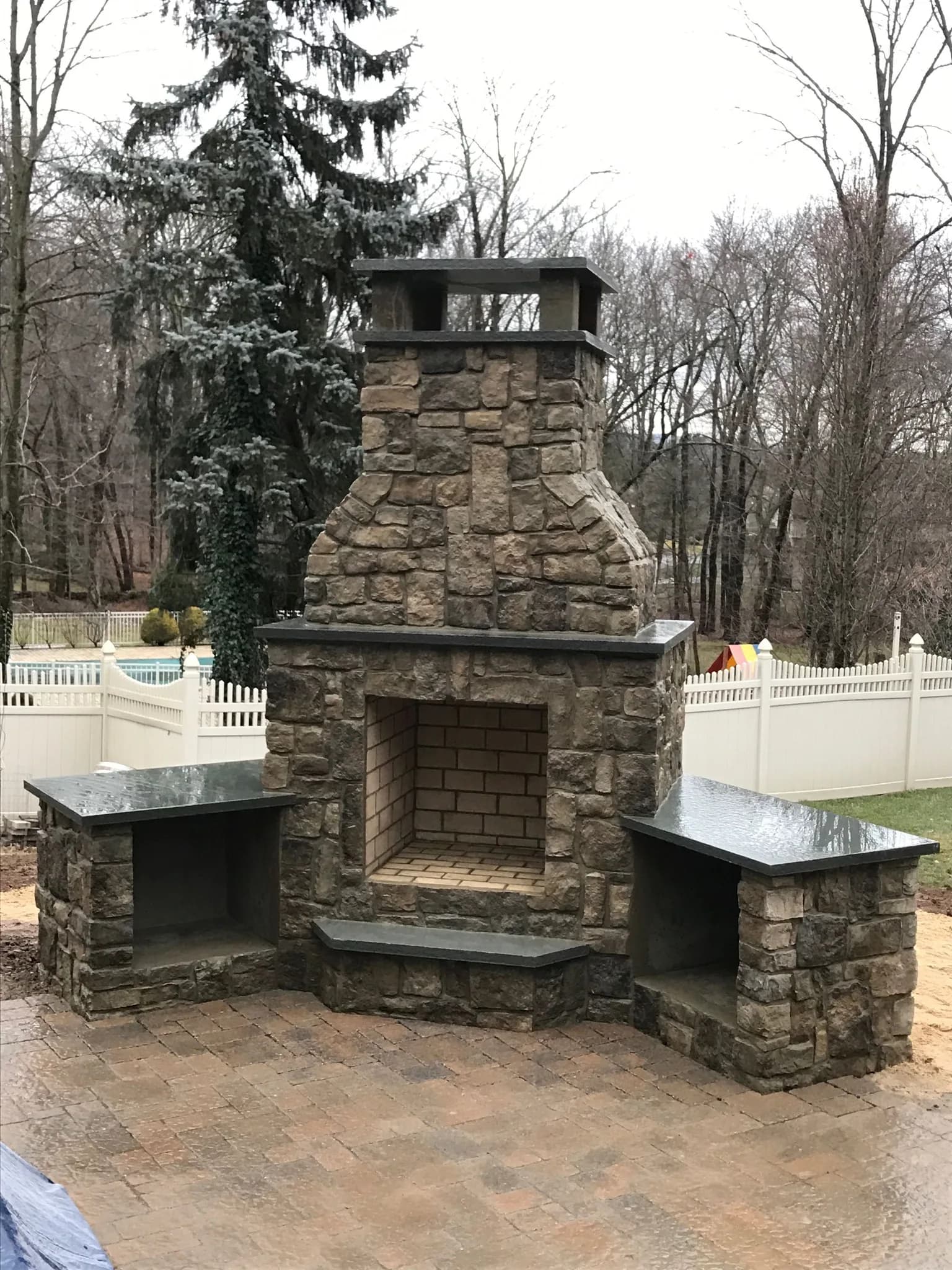 Stone patio shaded by a timber pergola