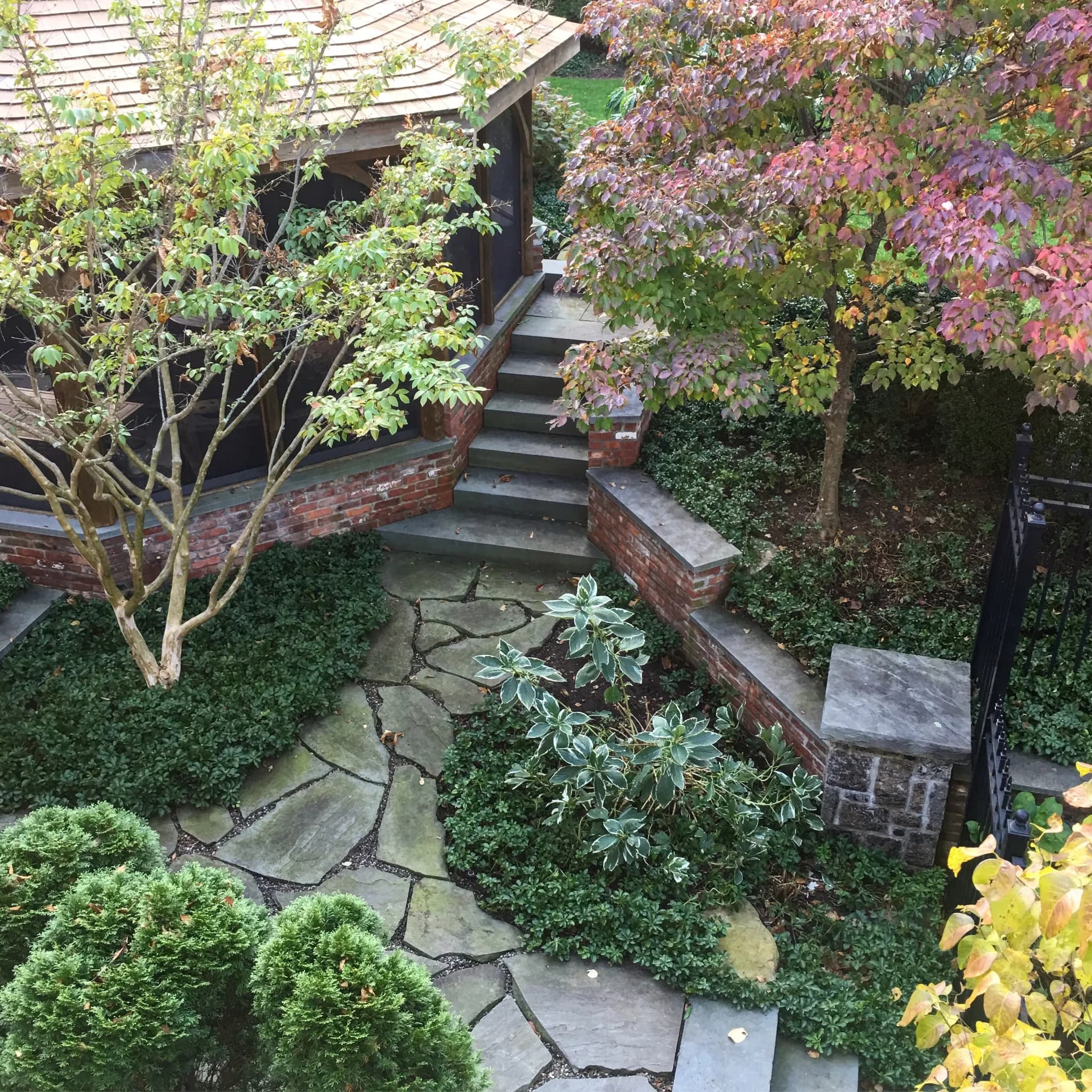 Designed landscape with layered plantings and stone hardscape