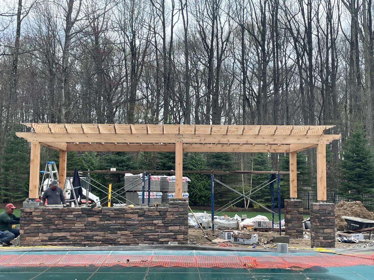 Outdoor kitchen build with stone counters and framing in progress