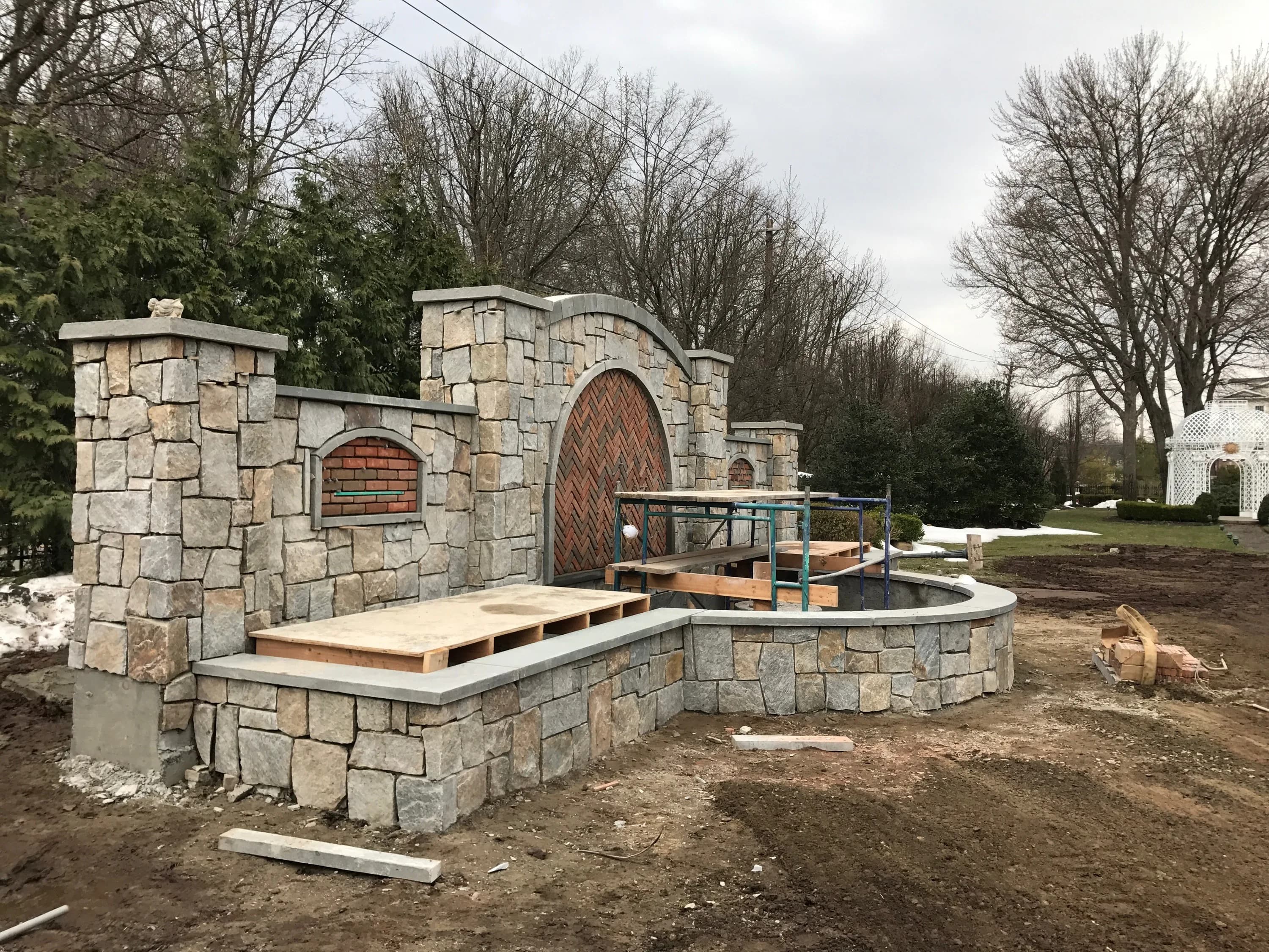 Stone fountain and water feature wall under masonry construction
