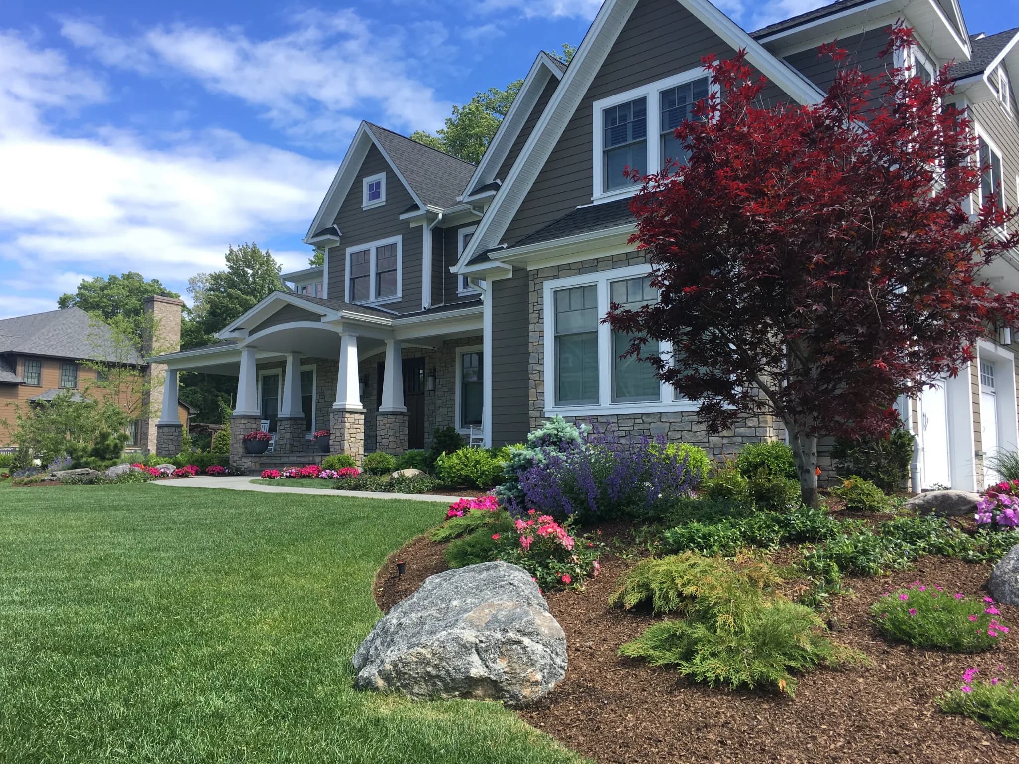 Manicured lawn and planting beds kept healthy by irrigation