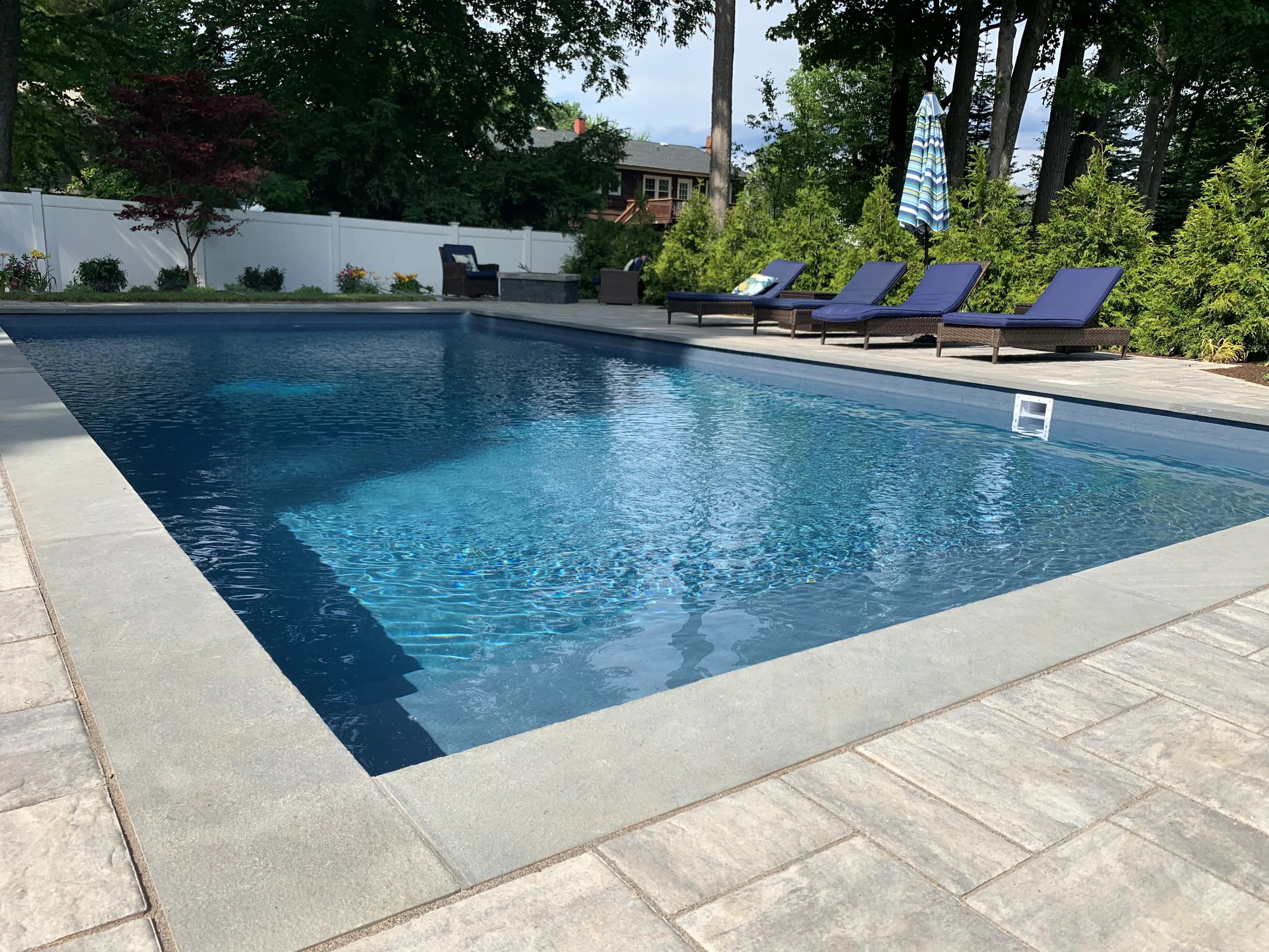 Gunite swimming pool with bluestone coping and a paver deck